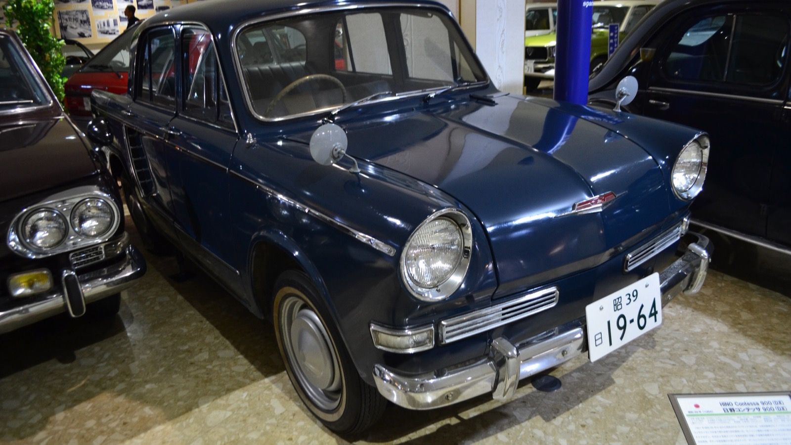 Dark blue 1964 Hino Contessa 900 Deluxe (PC10) sedan indoors, front three-quarter view