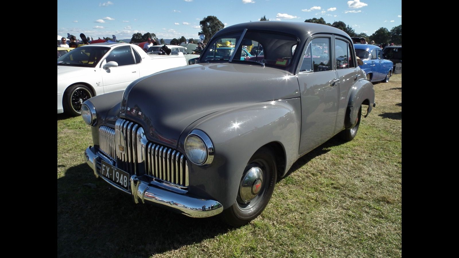 Grey 1948 Holden 48-215 (FX) sedan at a car show, front three-quarter view