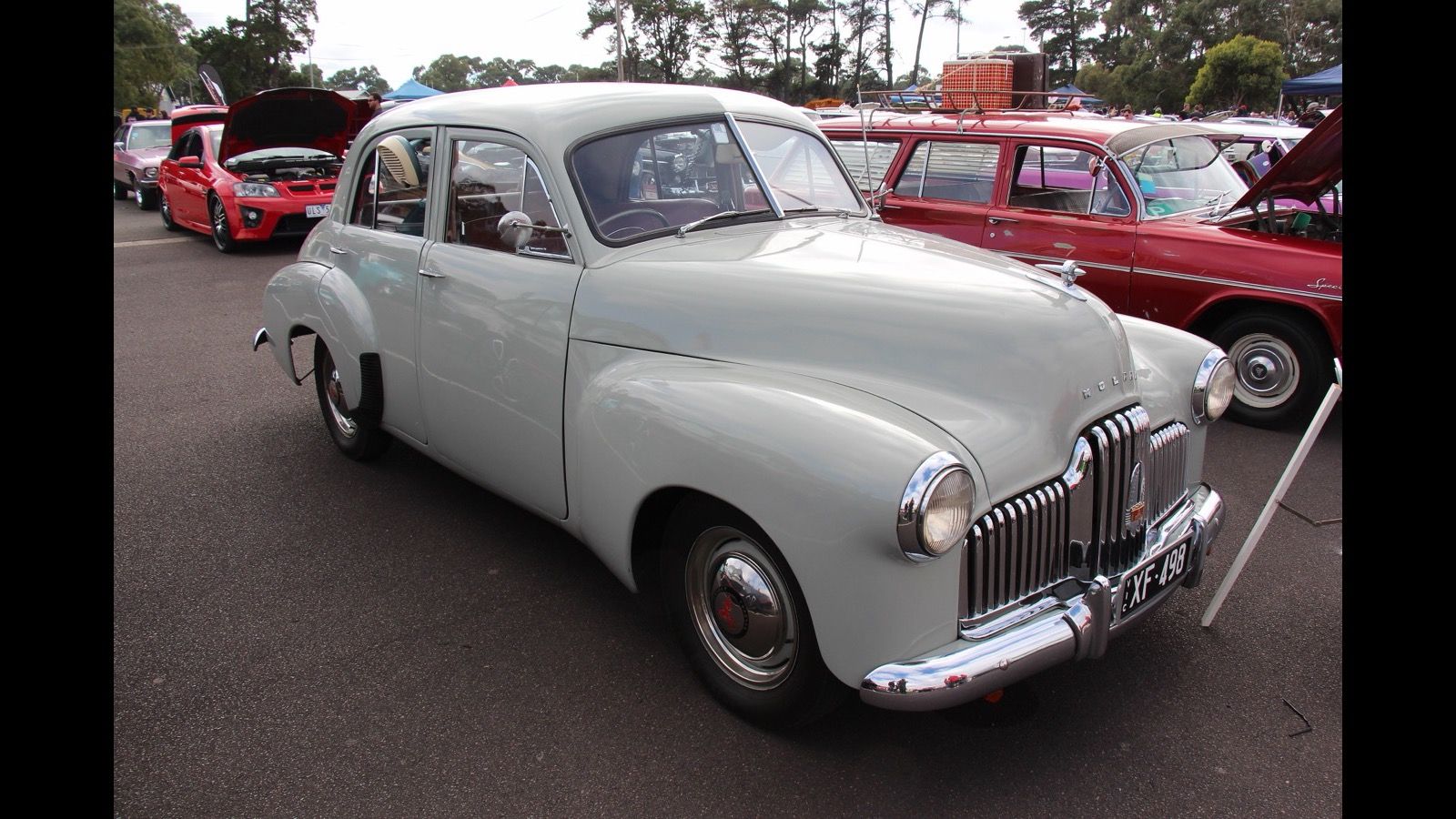 Pale grey 1950 Holden FX sedan parked at a car show, front three-quarter view