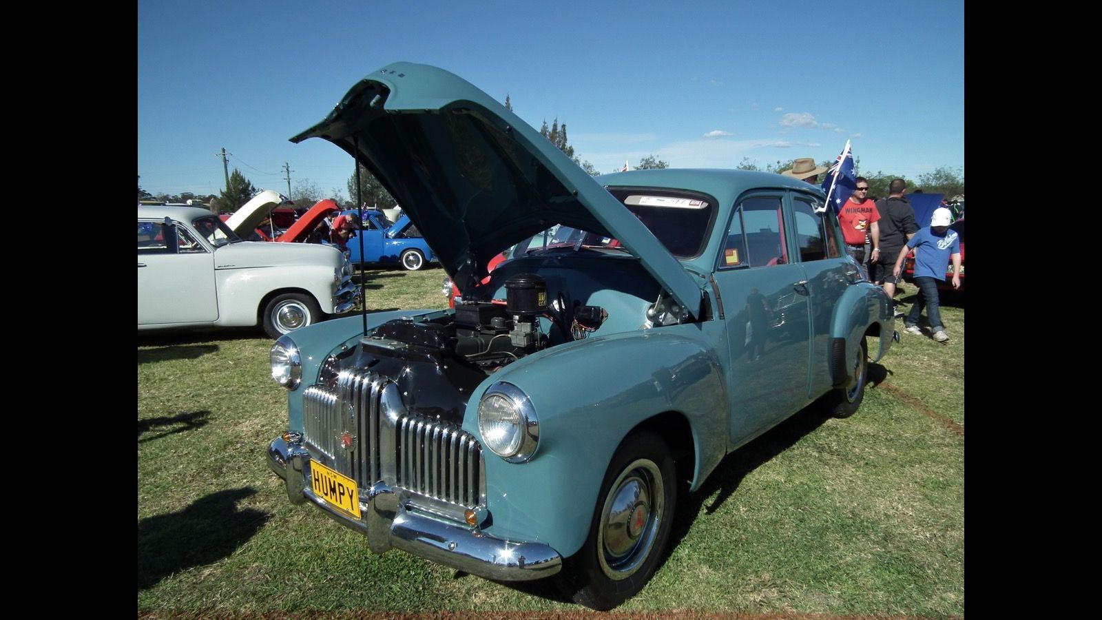 Light blue 1953 Holden 48-215 (FX) sedan with bonnet raised, front three-quarter view