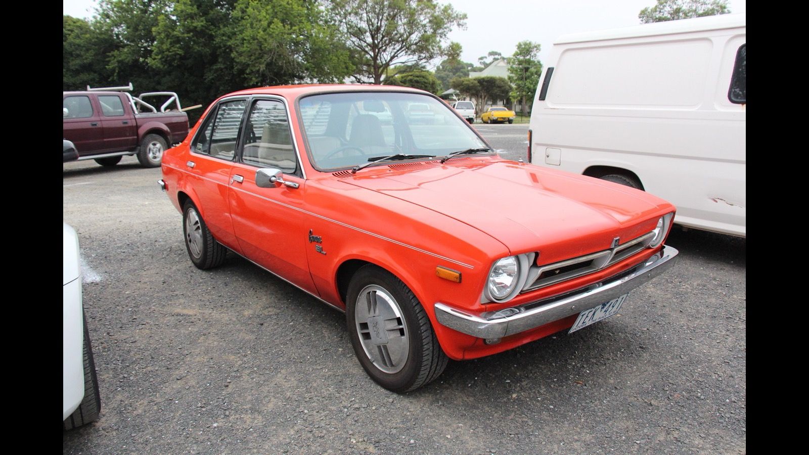 Orange-red 1976 Holden TX Gemini sedan, front three-quarter view
