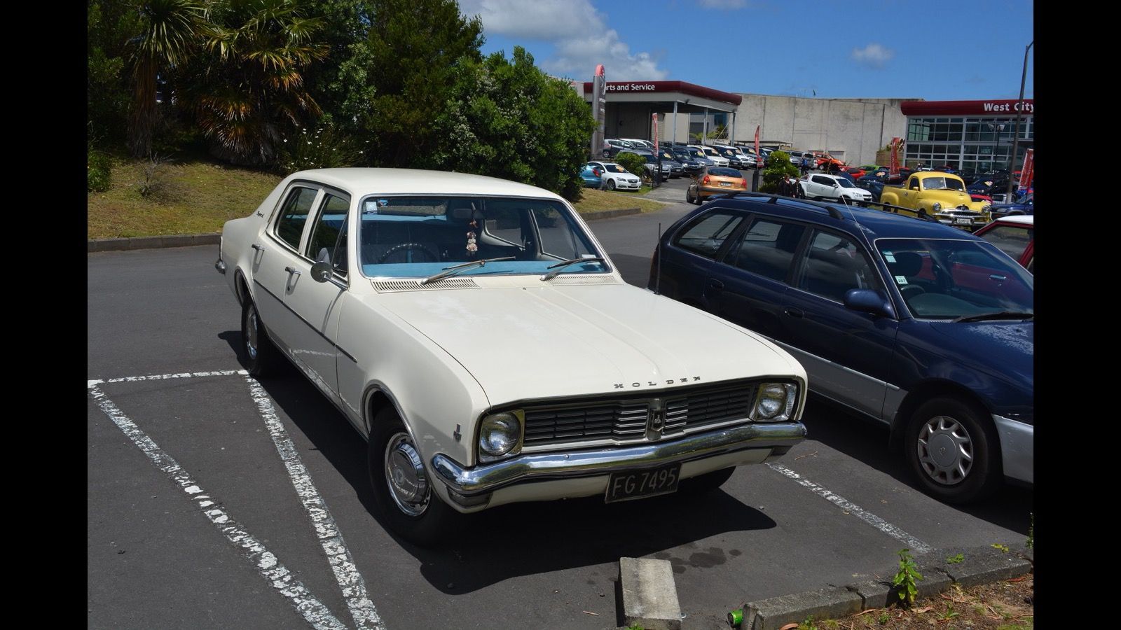 Cream 1970 Holden Kingswood sedan in a car park, front three-quarter view