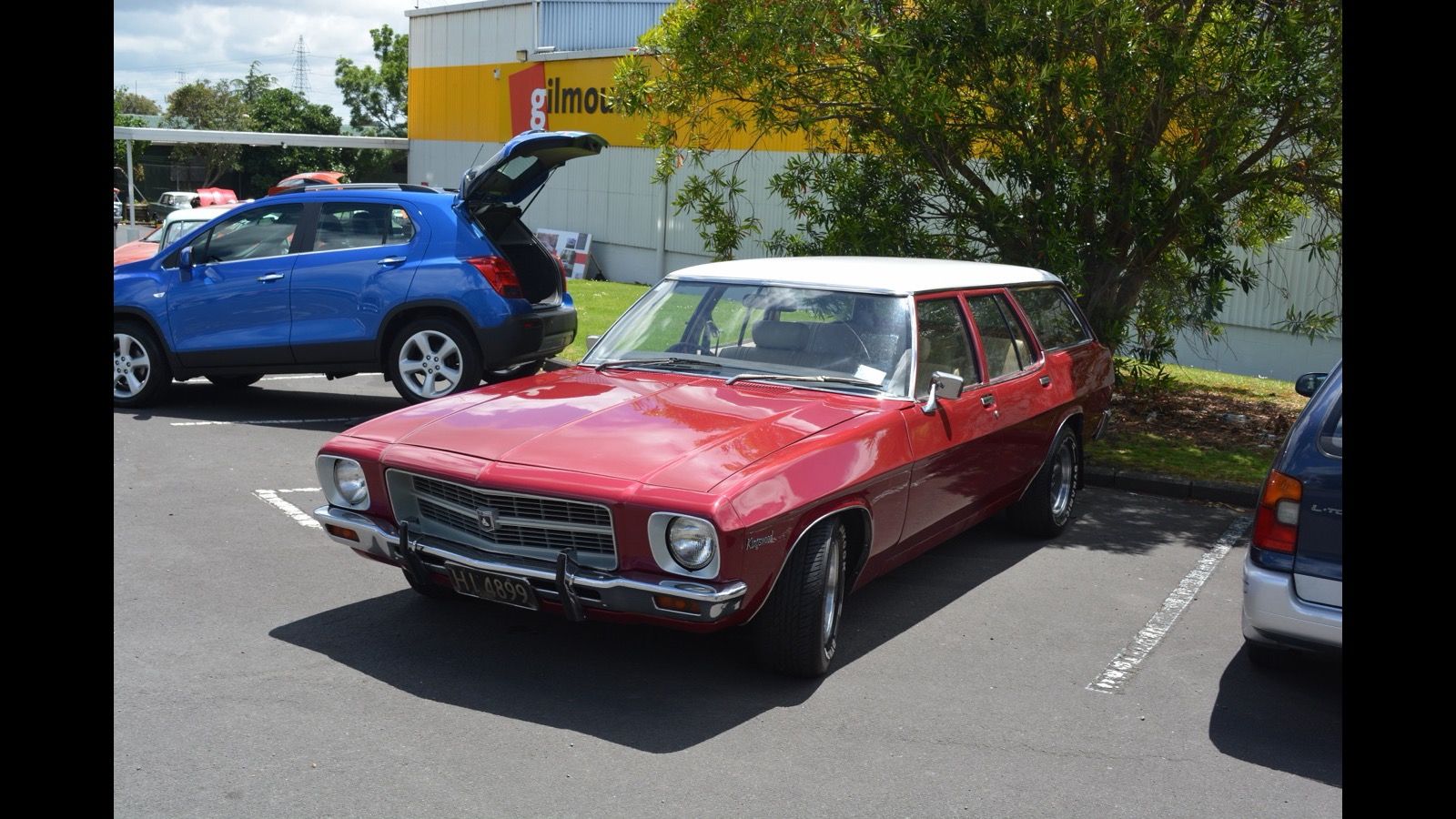 Red 1975 Holden Kingswood station wagon with white roof, front three-quarter view