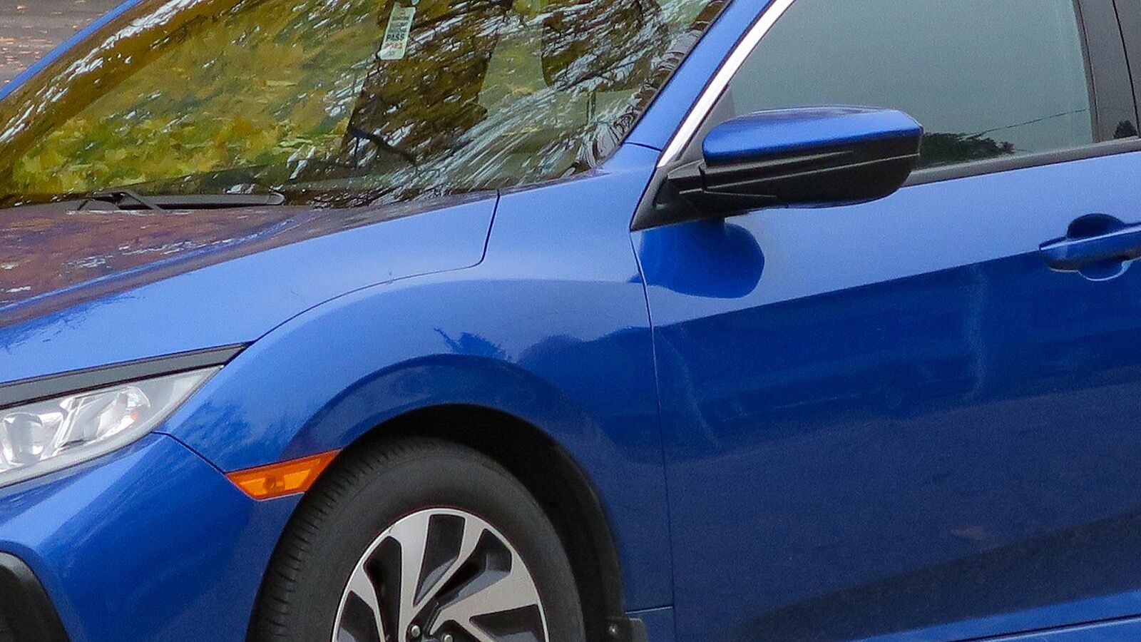 2018 Honda Civic — blue hatchback, front three-quarter view