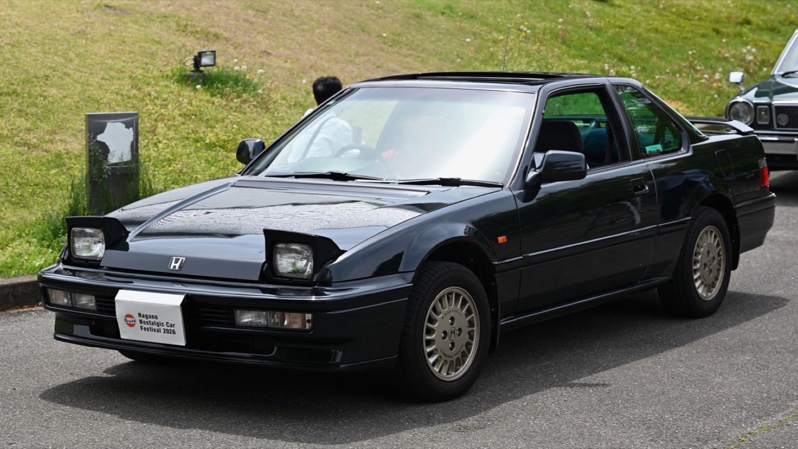 Dark green 1991 Honda Prelude Si with pop-up headlights raised, front three-quarter view