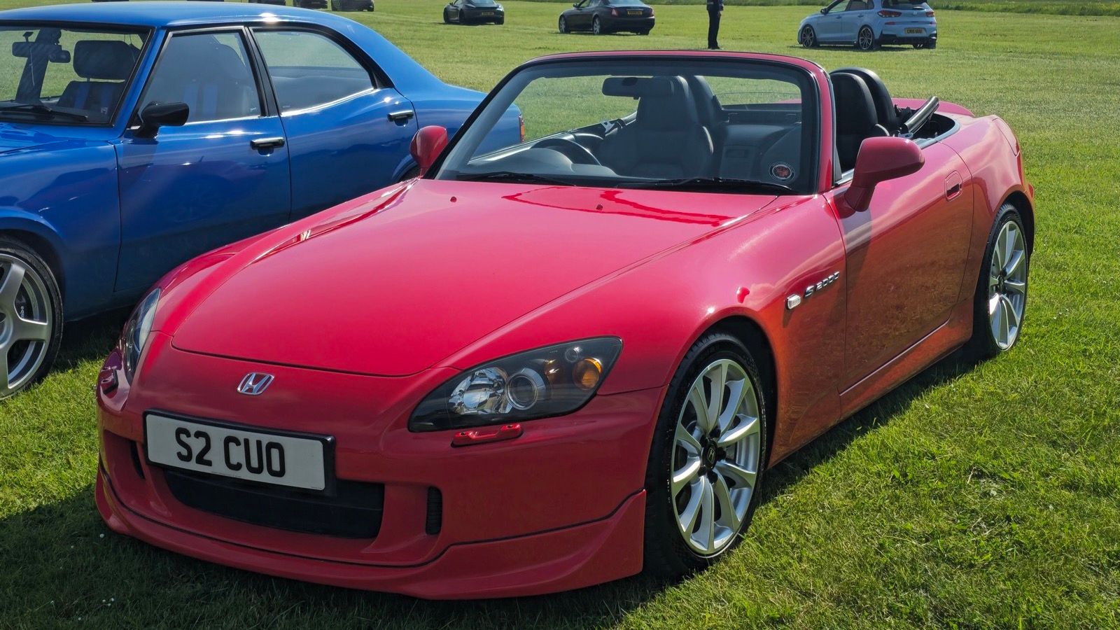 Red 2007 Honda S2000 roadster with top down, front three-quarter view