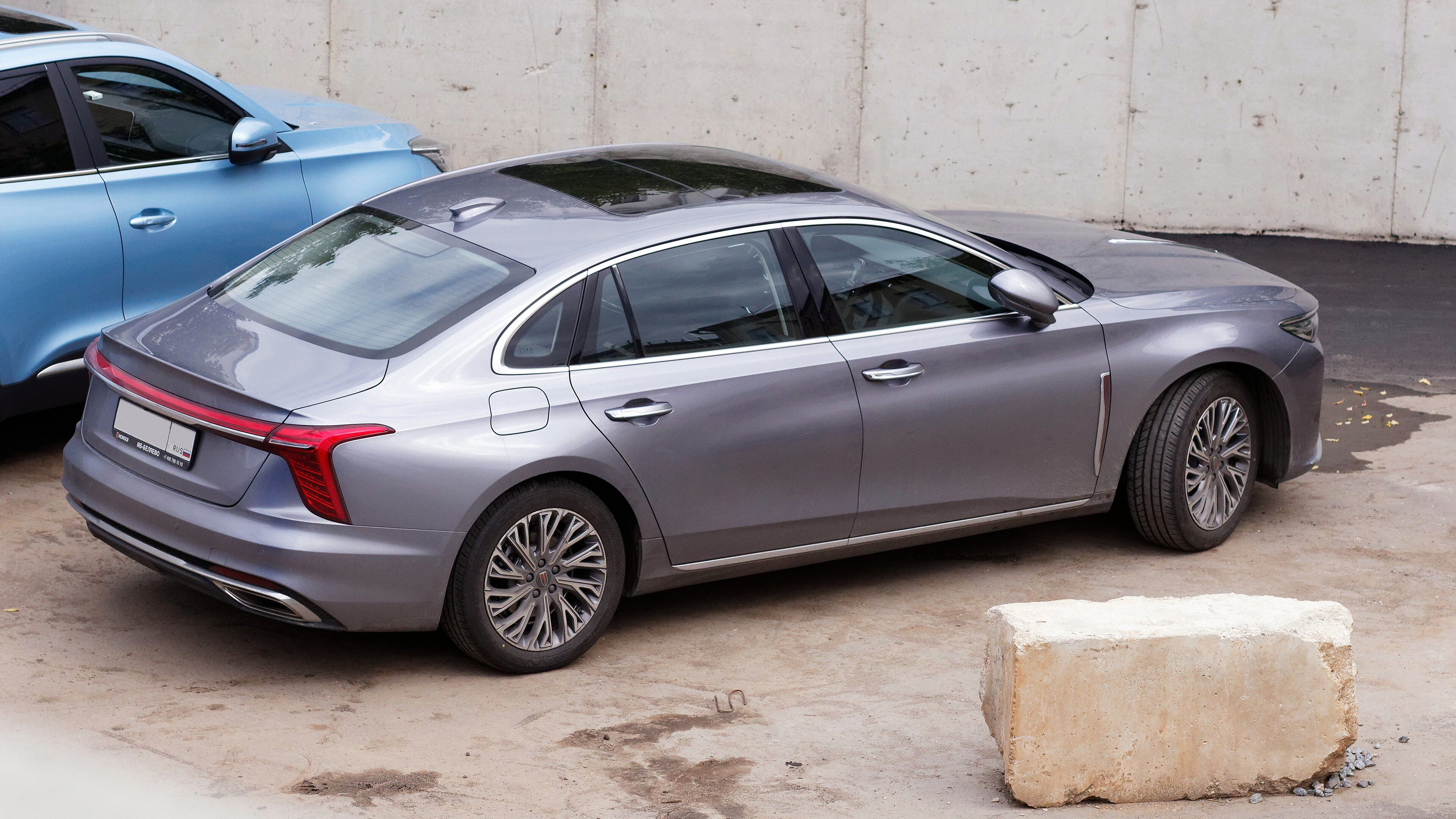 Grey second-generation Hongqi H5 sedan parked, rear three-quarter side profile.