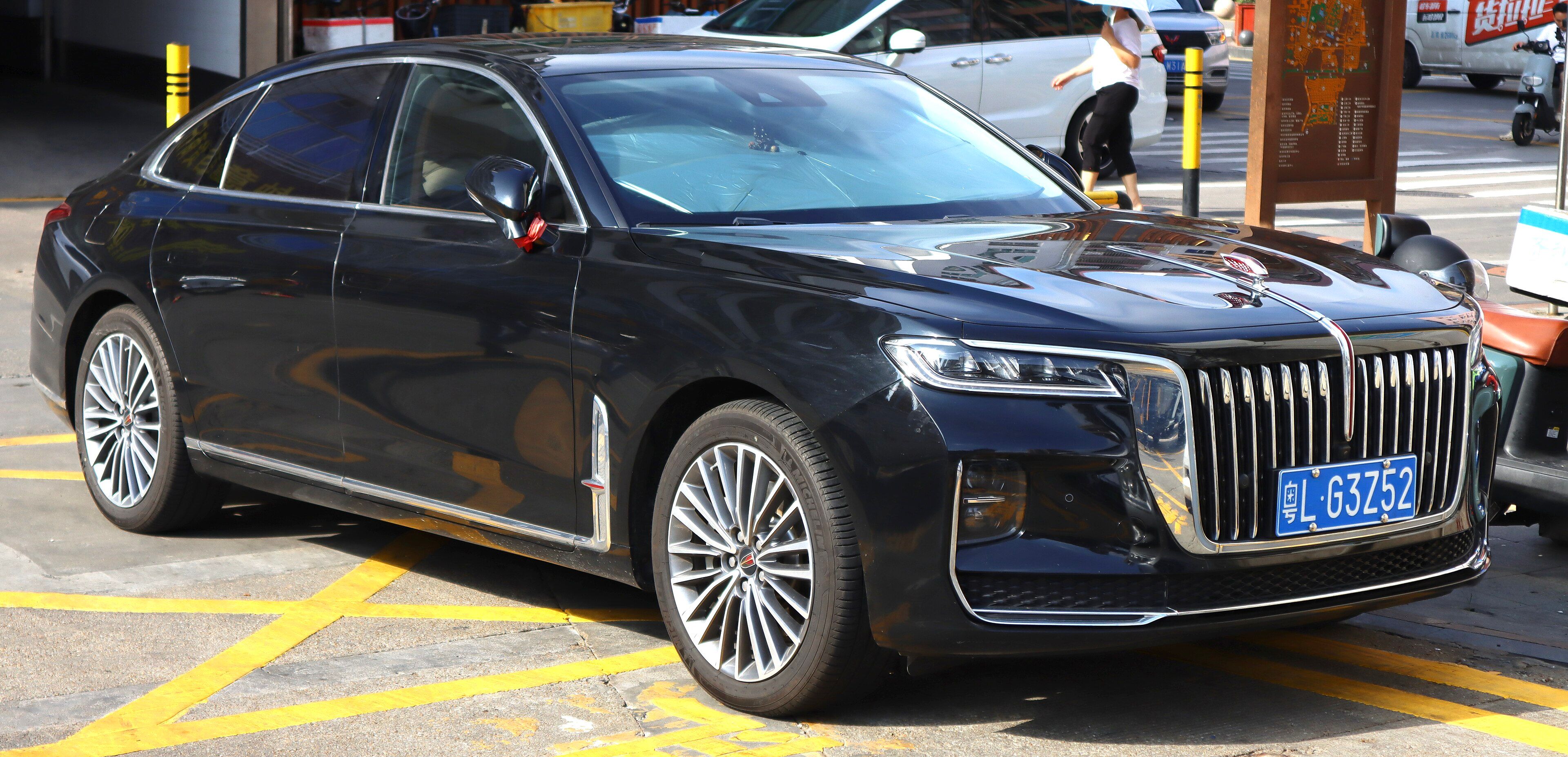 Dark blue 2020 Hongqi H9 sedan parked kerbside, front three-quarter view.