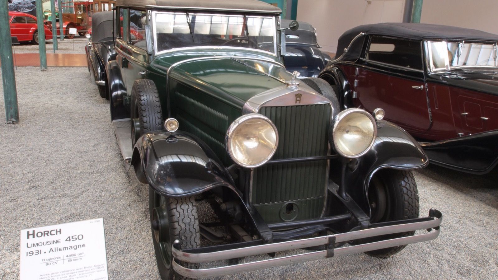 Green and black 1931 Horch 450 limousine on museum display, front three-quarter view