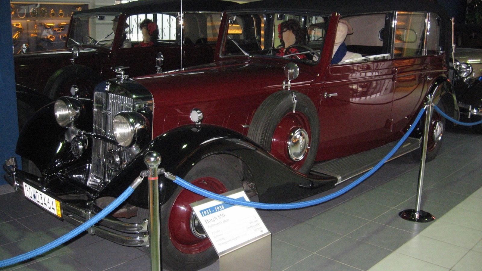 Maroon and black Horch 850 Pullman cabriolet on museum display, front three-quarter view
