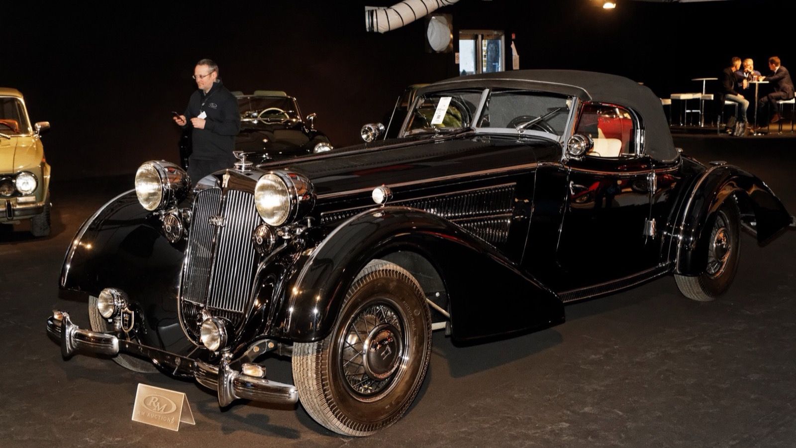 Black 1940 Horch 853 A Sport Cabriolet at a Paris auction preview, front three-quarter view