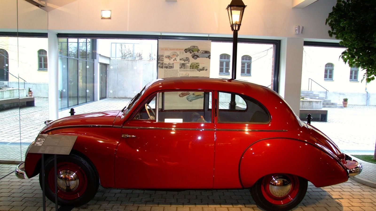 Side profile of a red IFA F9 saloon displayed at the August Horch Museum in Zwickau.