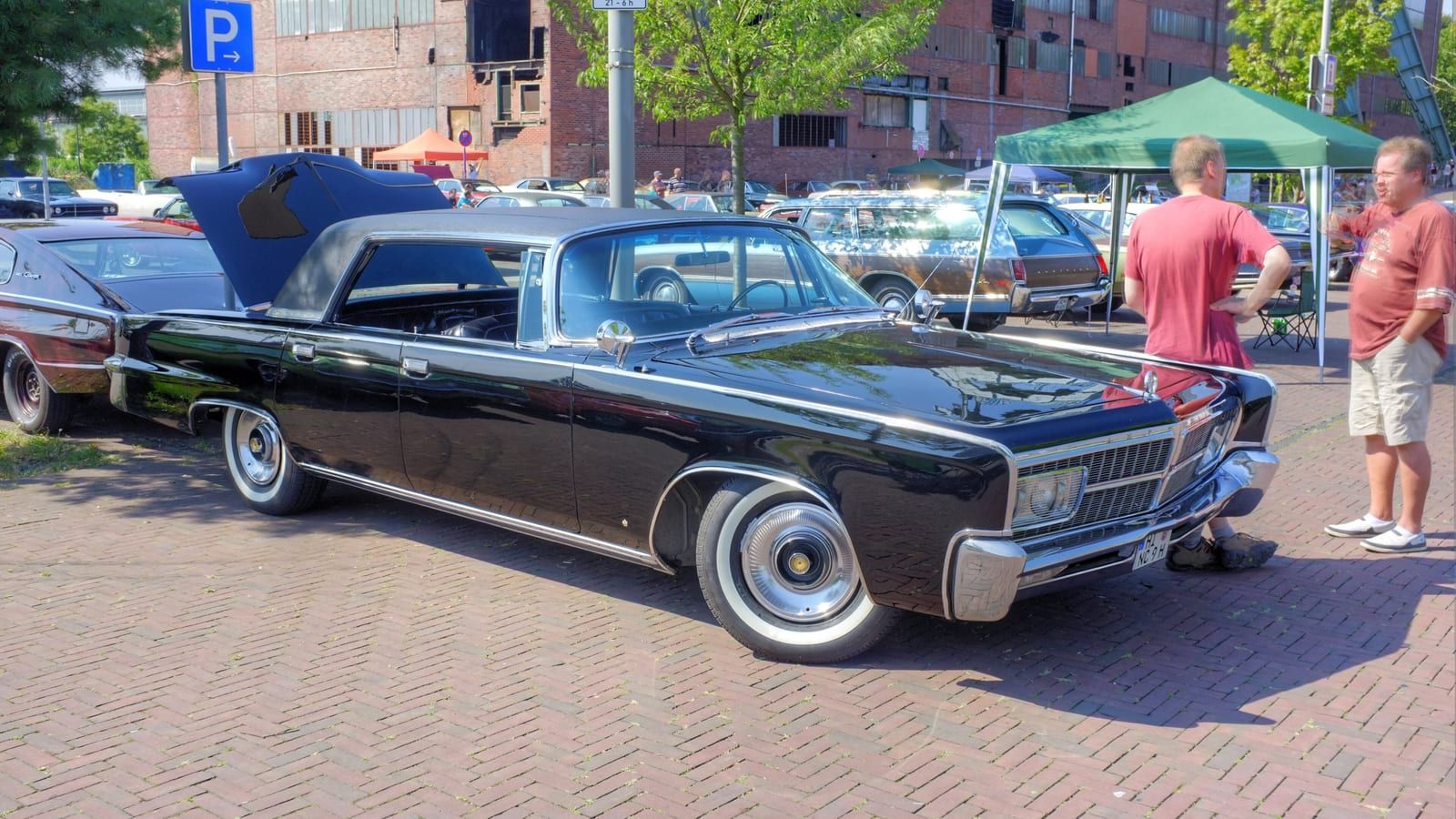 Black 1965 Imperial convertible with the top down, front three-quarter view.