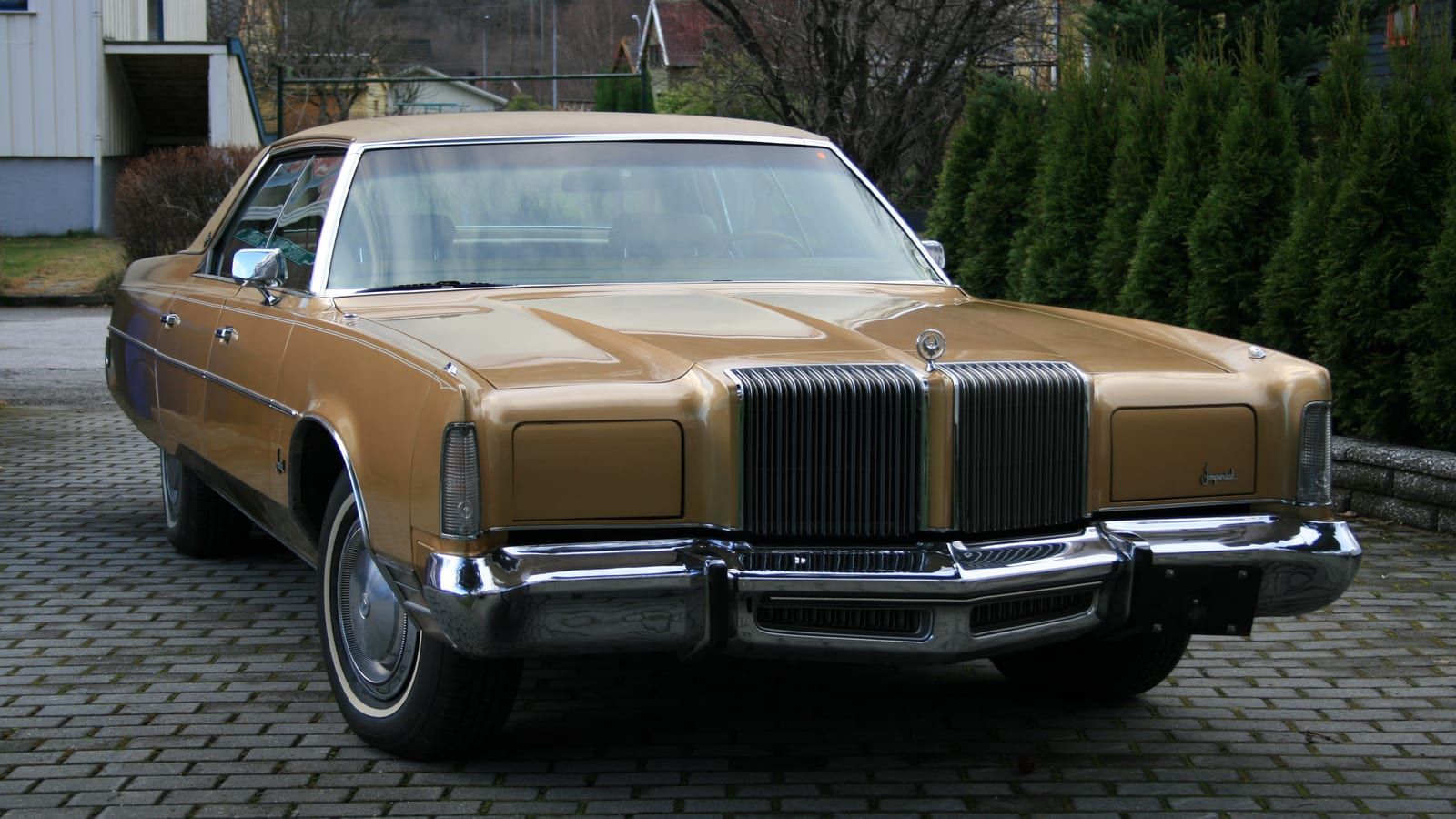 Gold 1975 Imperial LeBaron four-door hardtop, front three-quarter view.