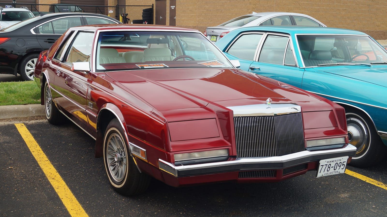 Red 1982 Imperial bustle-back coupe, front three-quarter view.