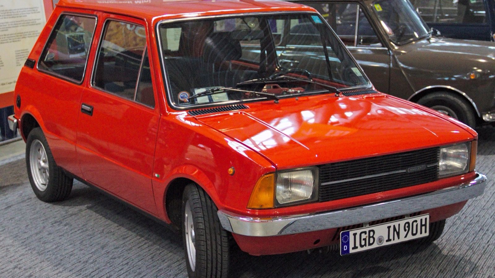 Red 1979 Innocenti Mini 90 SL three-door hatchback on display, front three-quarter view