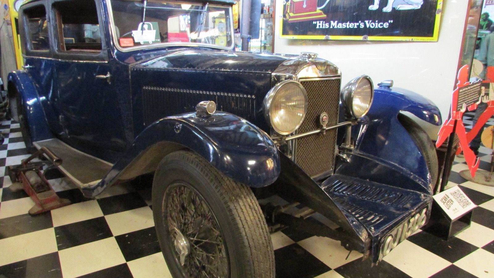 Dark blue 1932 Invicta 4½-litre sports saloon, front three-quarter view on display at the Cotswold Motoring Museum