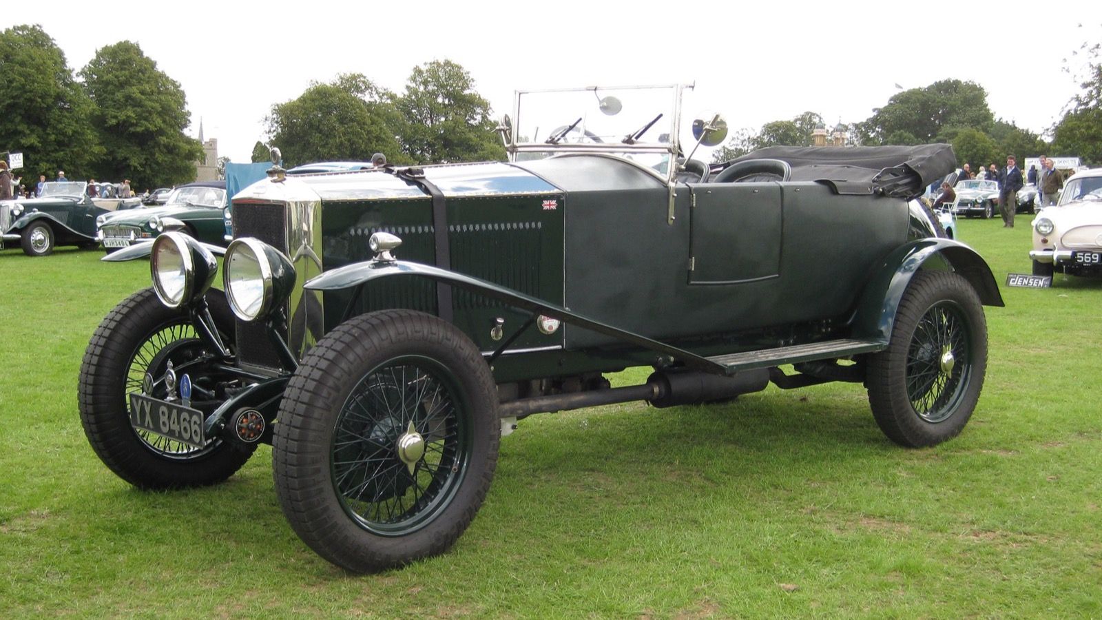 Dark green high-chassis Invicta 4½-litre open tourer of about 1930, front three-quarter view on grass at a car show