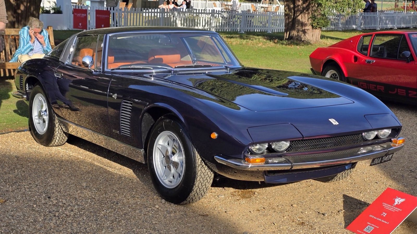Dark-blue 1972 Iso Grifo Series II coupe on gravel, front three-quarter view
