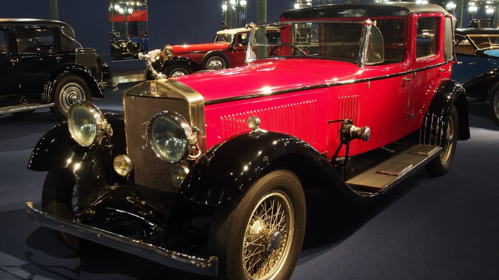 Red and black 1925 Isotta Fraschini Tipo 8A berline on museum display, front three-quarter view