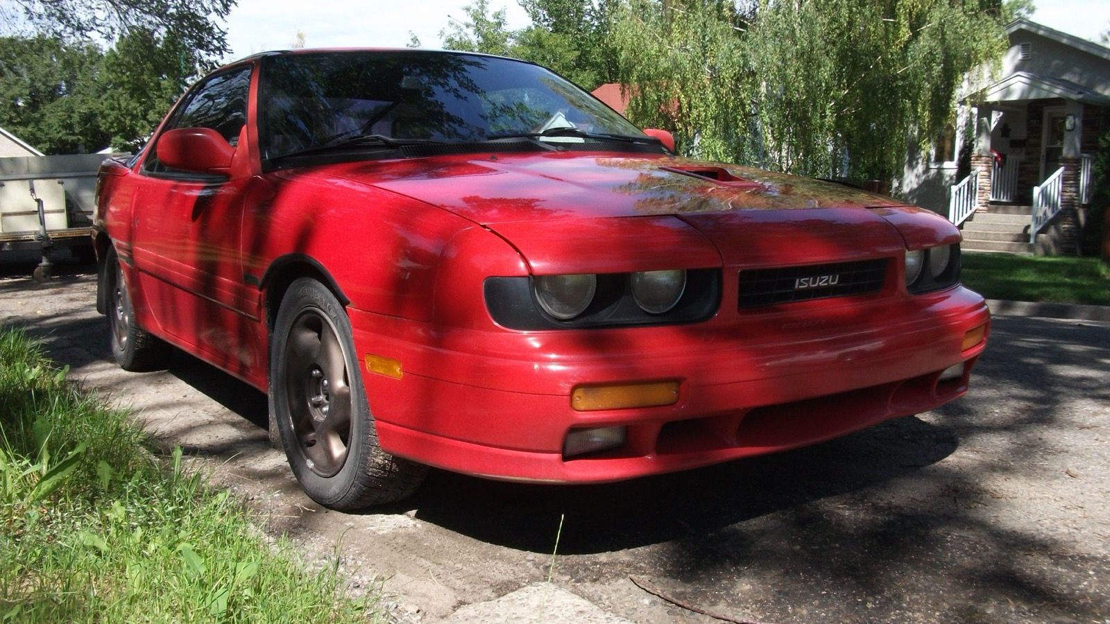 Red 1991 Isuzu Impulse RS Turbo all-wheel-drive coupe, front three-quarter view
