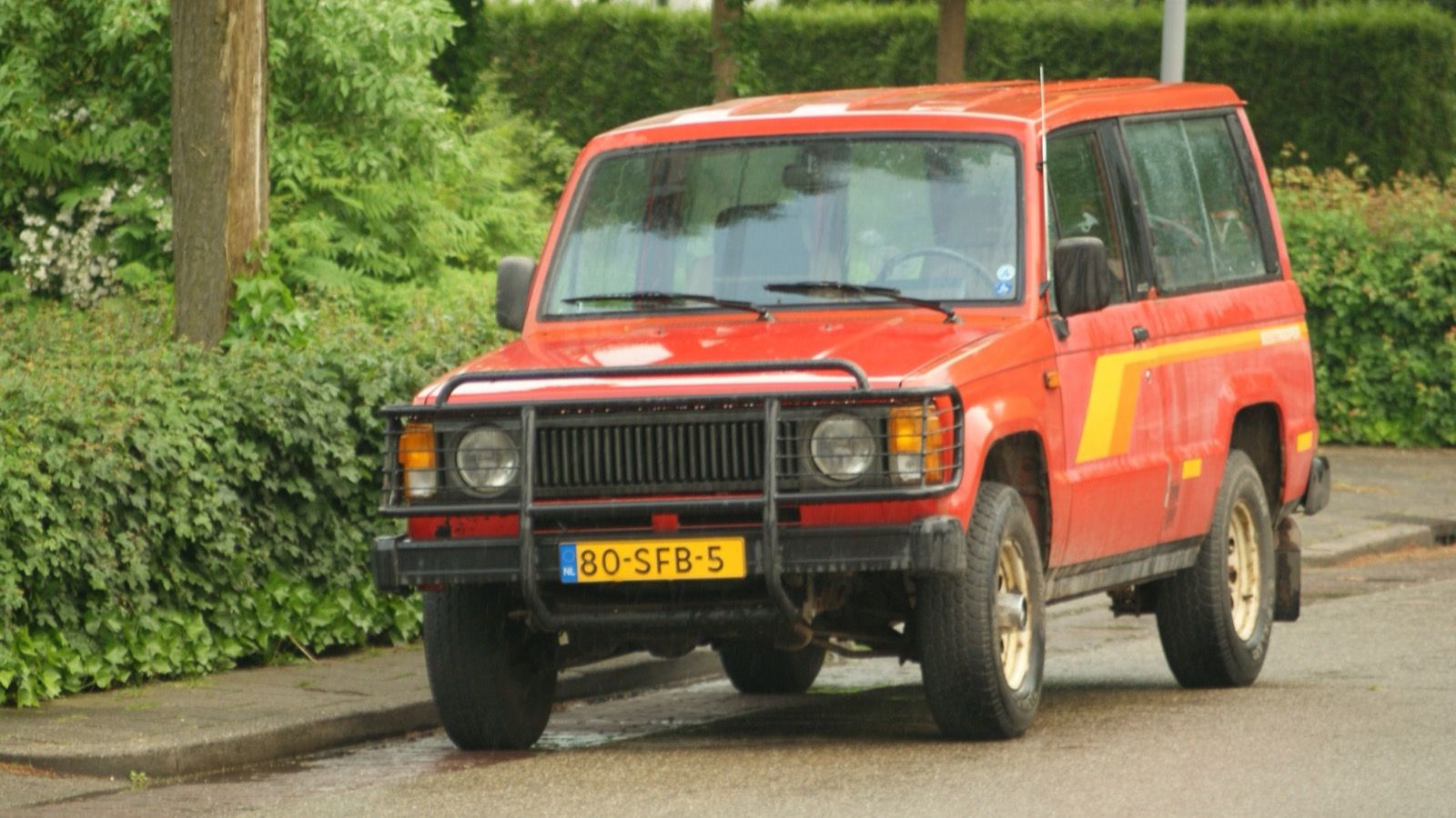Red 1984 Isuzu Trooper five-door 4x4, front three-quarter view