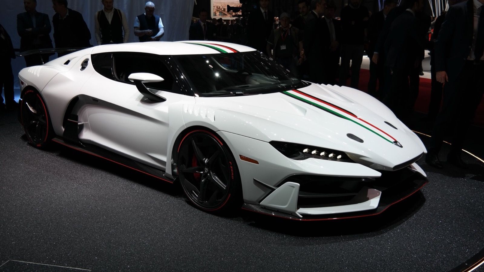 White Italdesign Zerouno coupé with Italian tricolour stripe on the Geneva Motor Show stand, front three-quarter view
