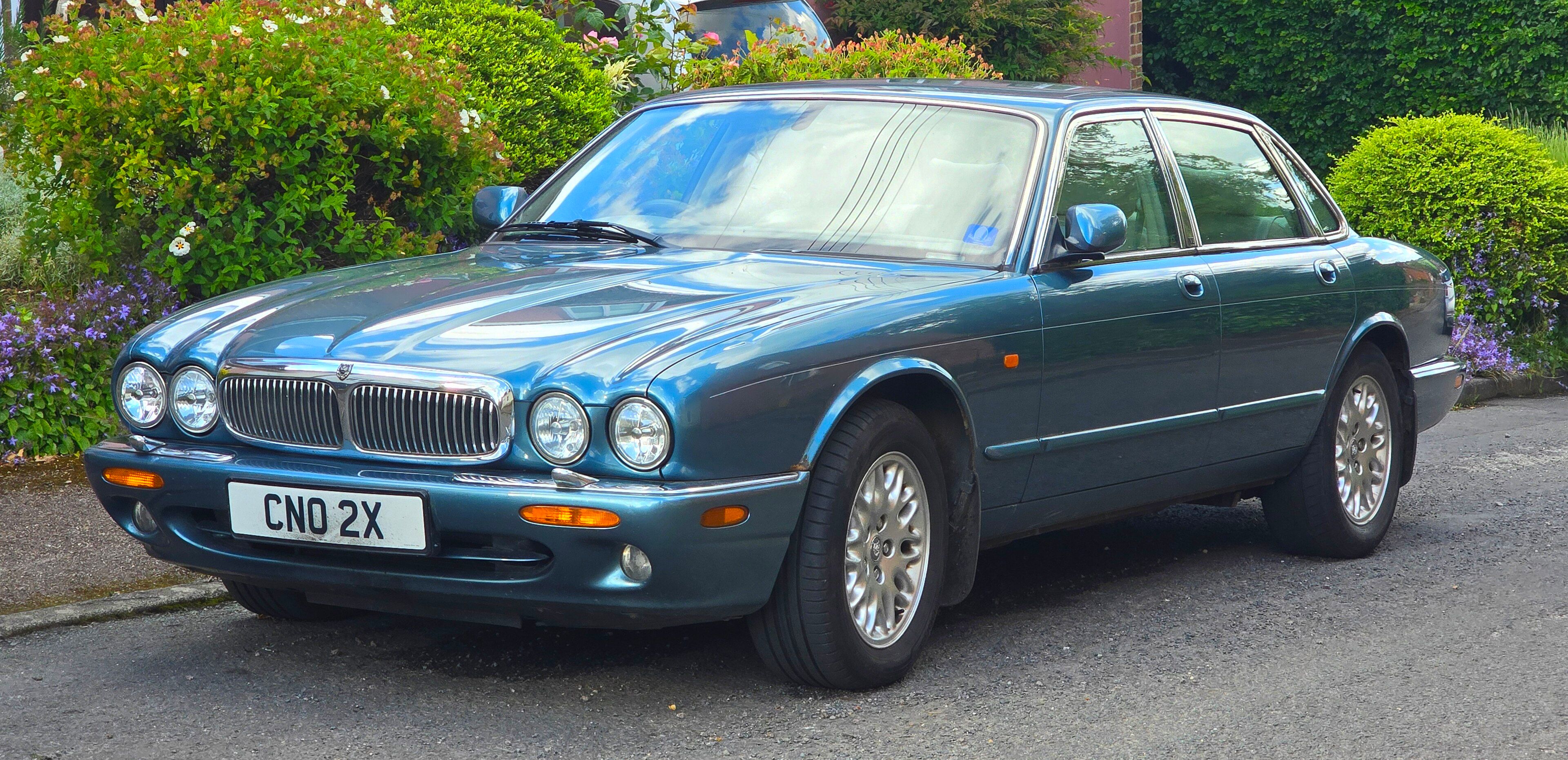 Light blue 2000 Jaguar XJ Executive X308 saloon parked on a driveway, front three-quarter view