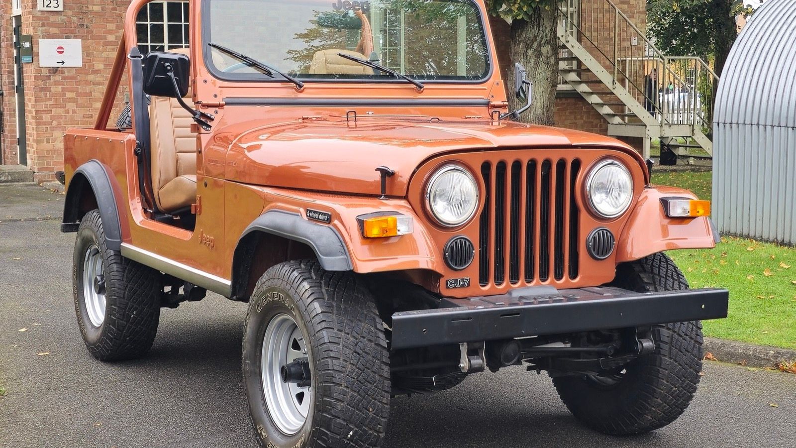 Copper-orange 1981 Jeep CJ-7 open-top 4x4, front three-quarter view