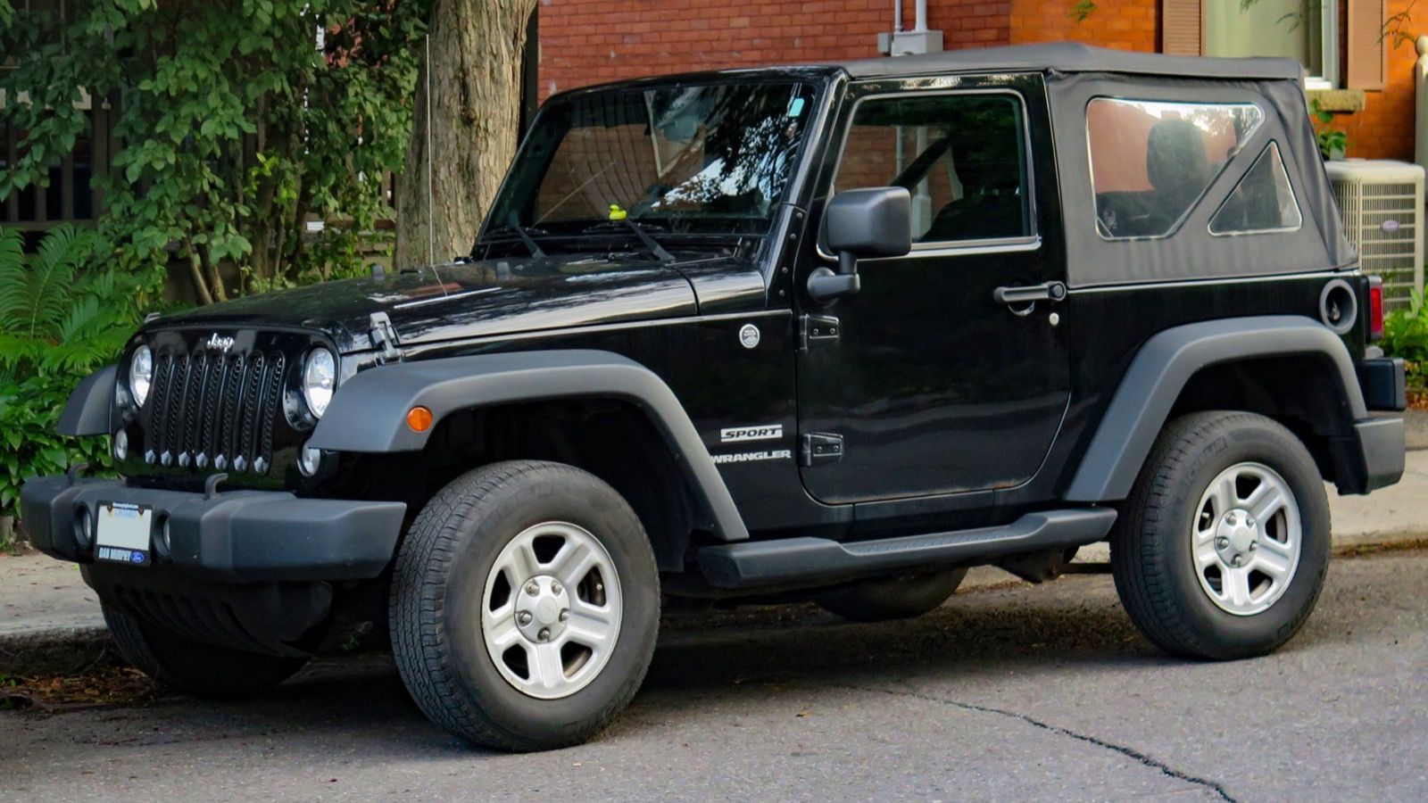 2014 Jeep Wrangler JK Sport in black, front three-quarter view