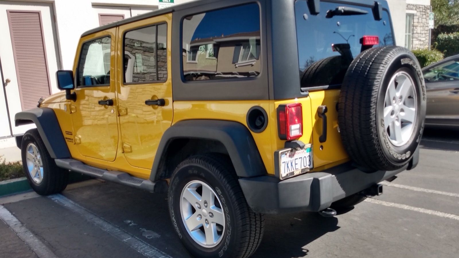 2015 Jeep Wrangler JK Unlimited Sport, front three-quarter view