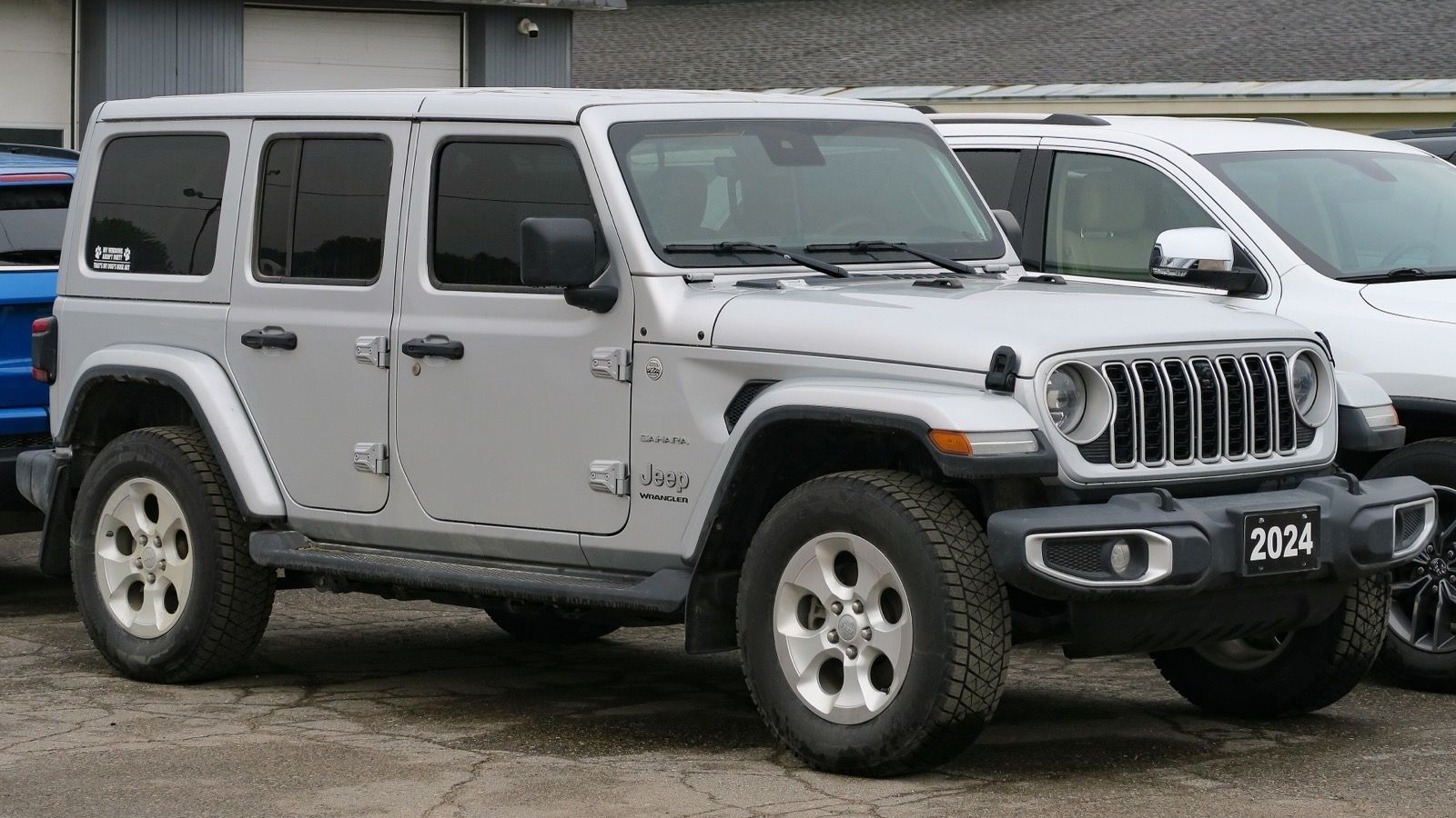 2024 Jeep Wrangler JL four-door Sahara in silver, front three-quarter view