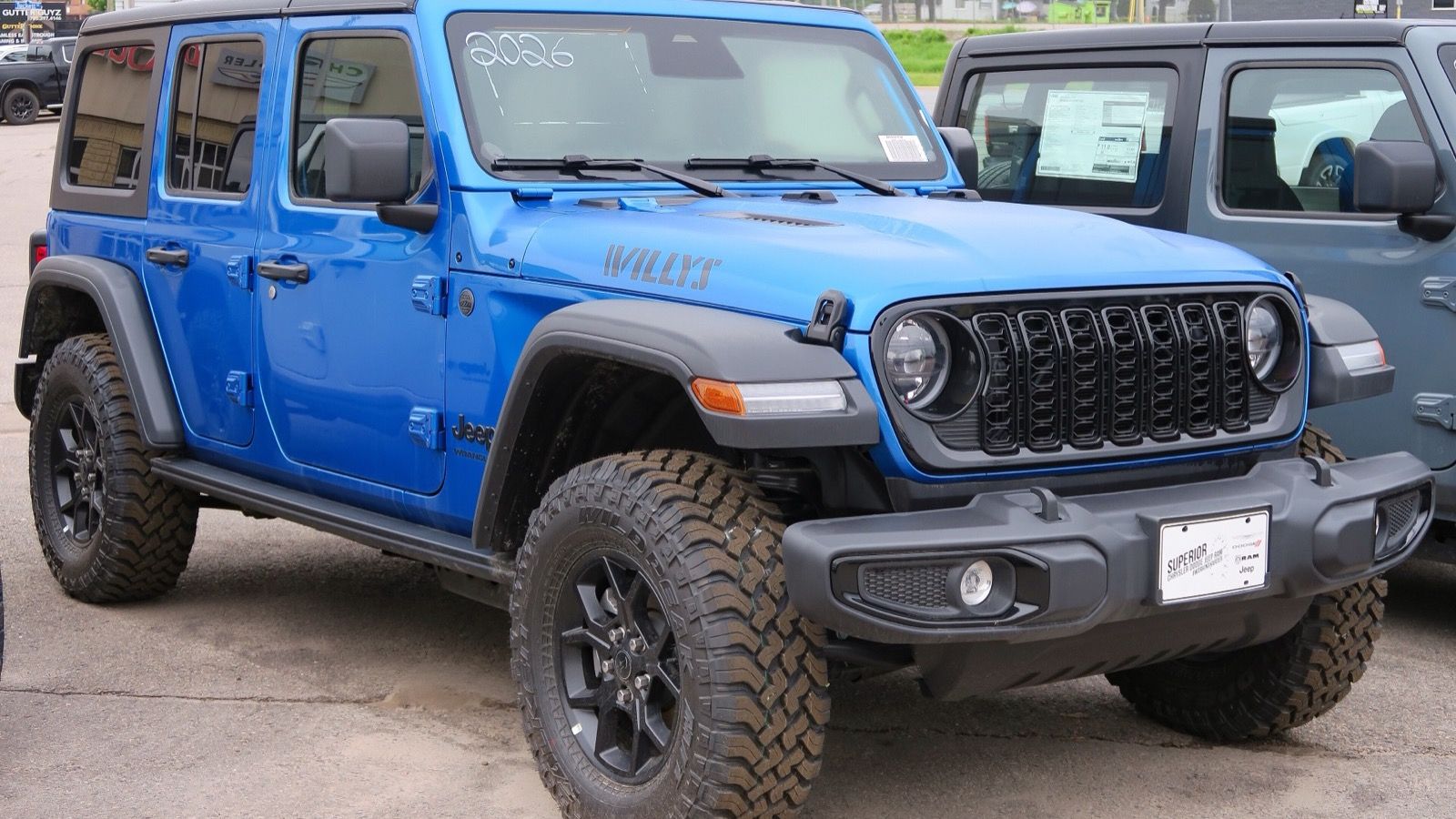 2026 Jeep Wrangler JL four-door Willys in blue, front three-quarter view