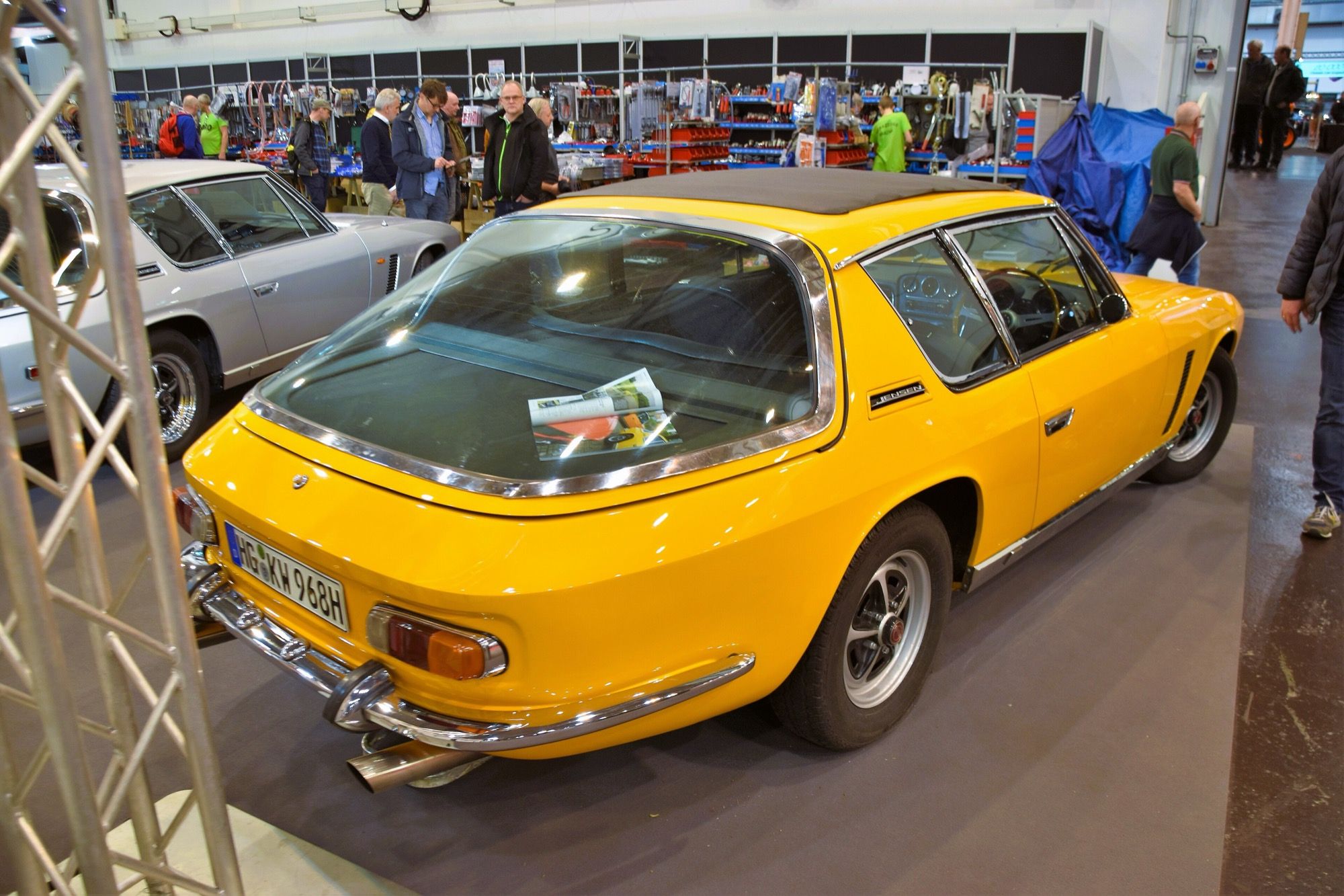 Yellow 1968 Jensen Interceptor Series I, rear three-quarter view showing the wrap-around glass hatch