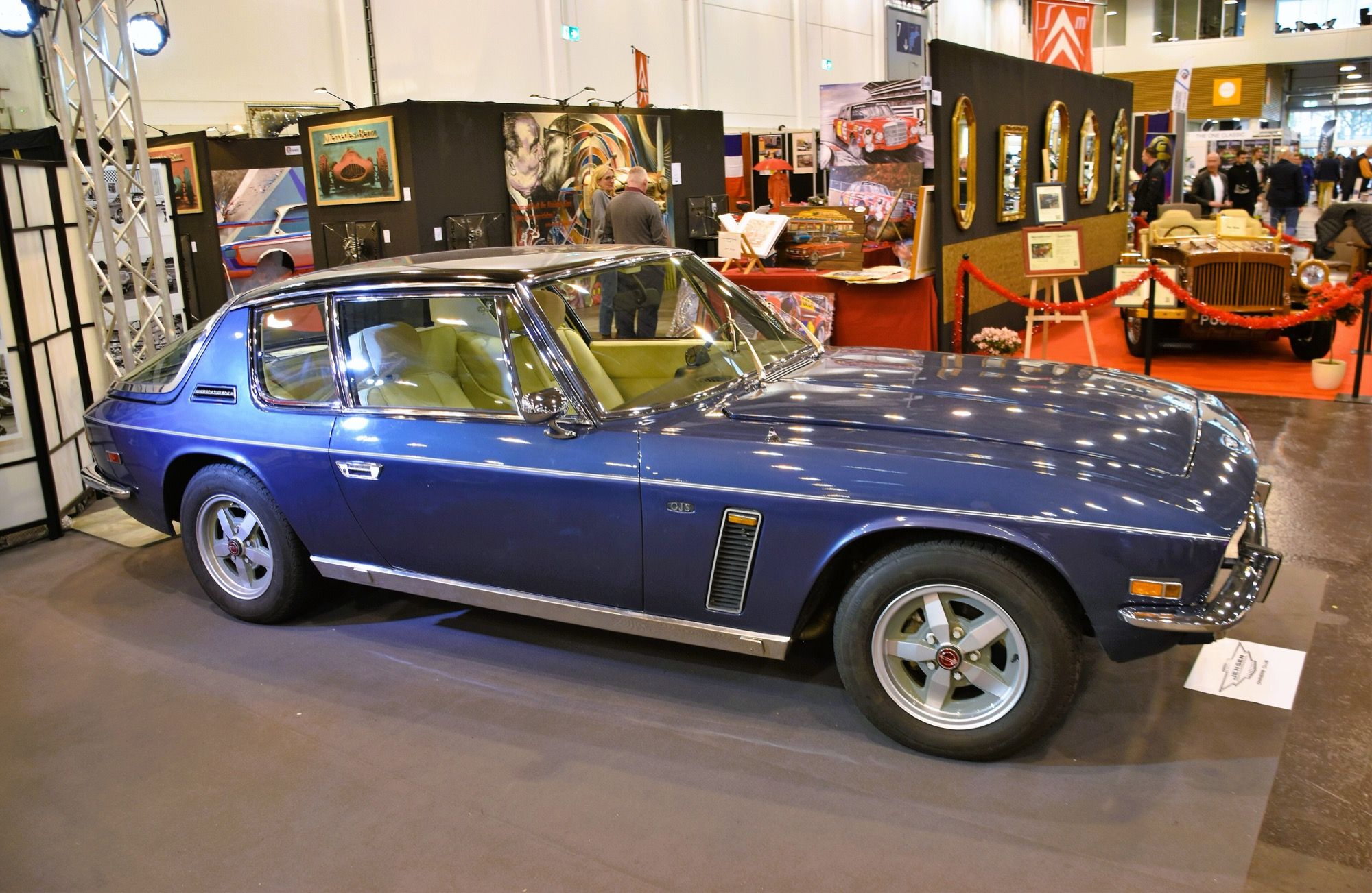 Dark blue 1975 Jensen Interceptor Series III on indoor display, front three-quarter view