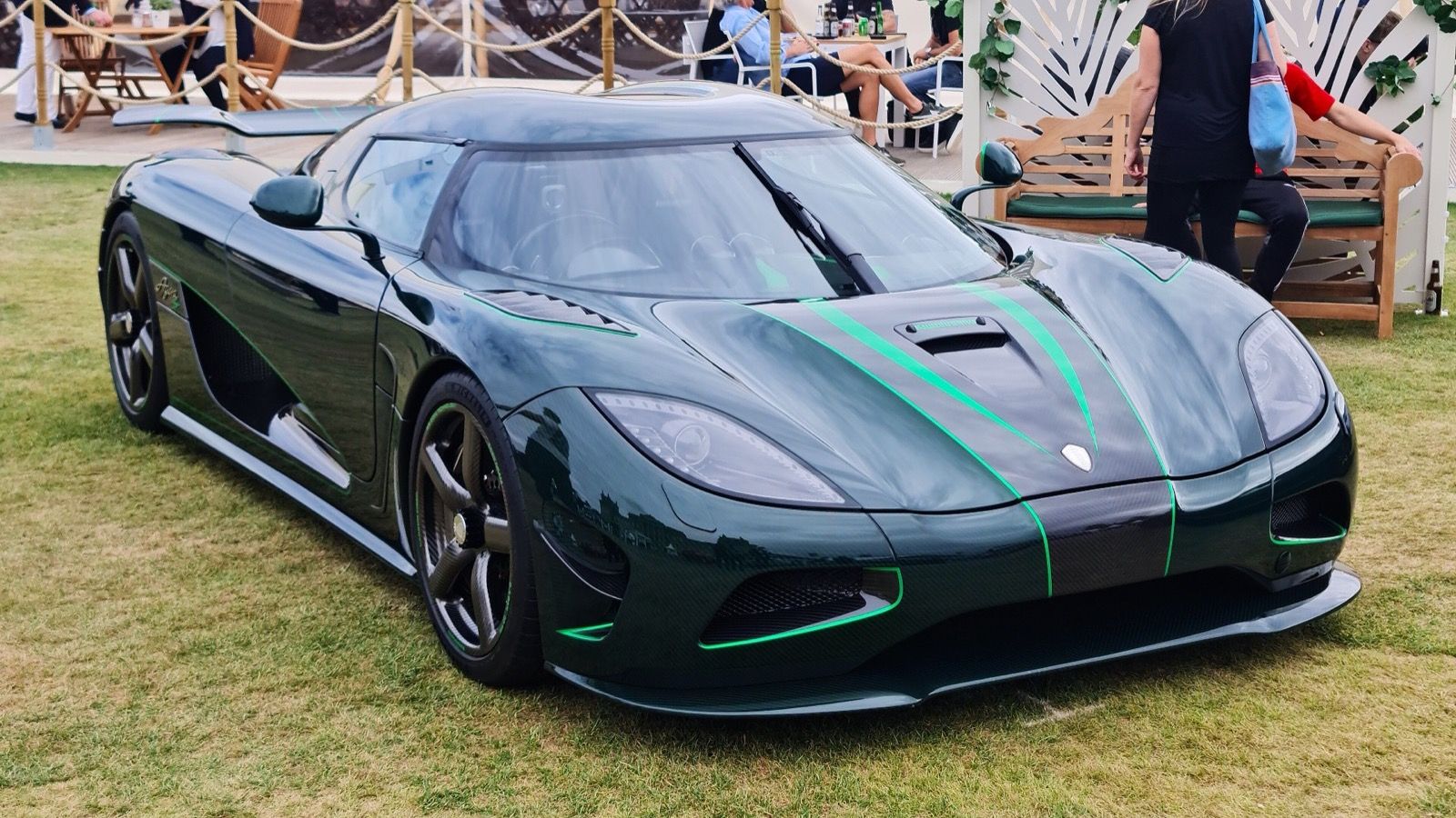 Dark green 2012 Koenigsegg Agera S with green accent stripes, front three-quarter view