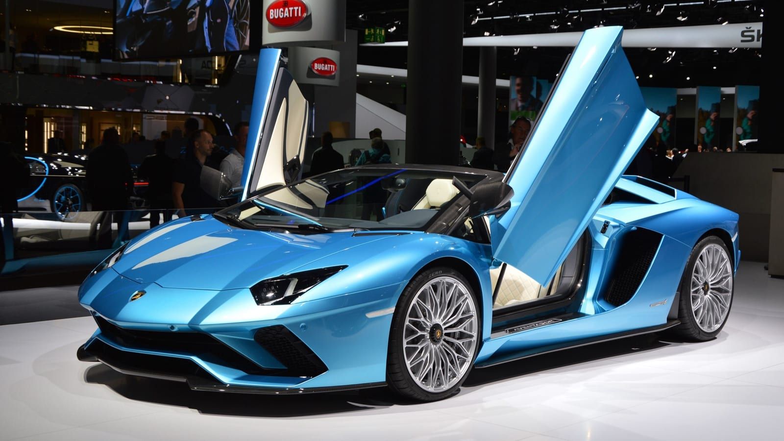 Blue 2017 Lamborghini Aventador S Roadster with door raised, front three-quarter view