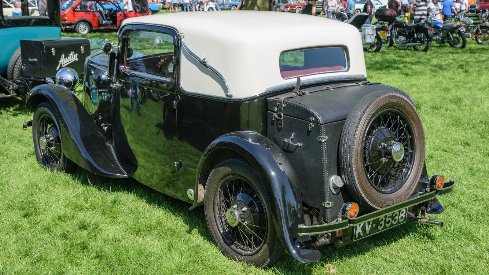 Black 1932 Lanchester Ten fixed-head coupé with rear-mounted spare wheel, rear three-quarter view