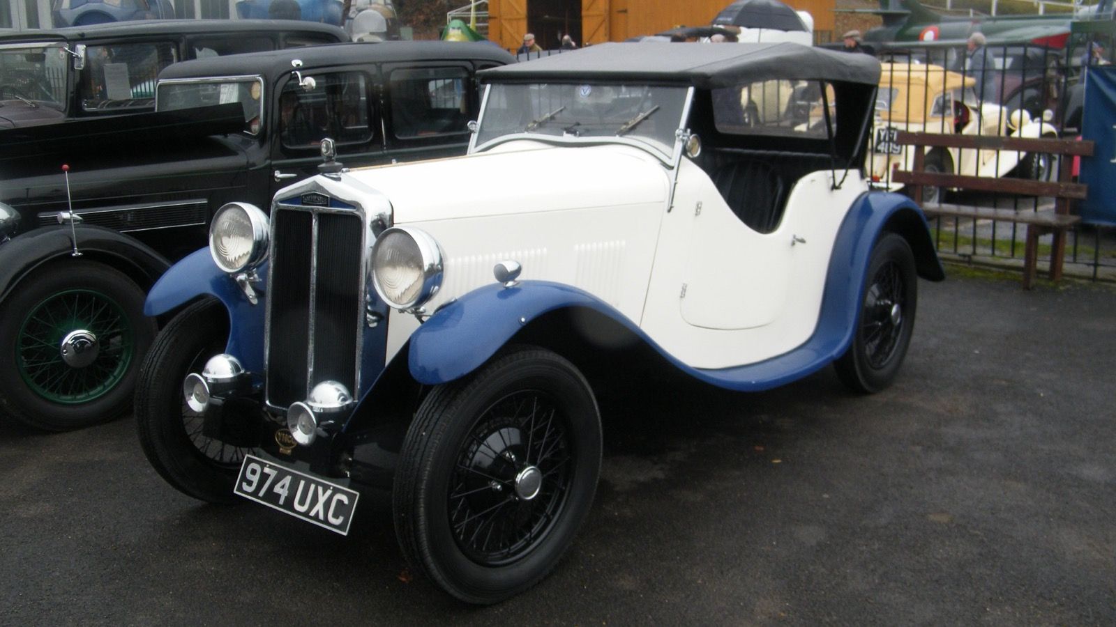 White and blue 1934 Lanchester Ten open tourer with the hood raised, front three-quarter view