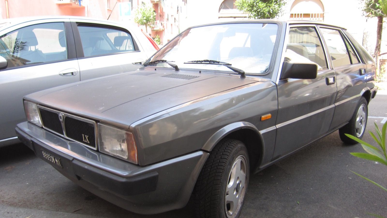Grey 1984 Lancia Delta LX 1300 parked on an Italian street, front three-quarter view