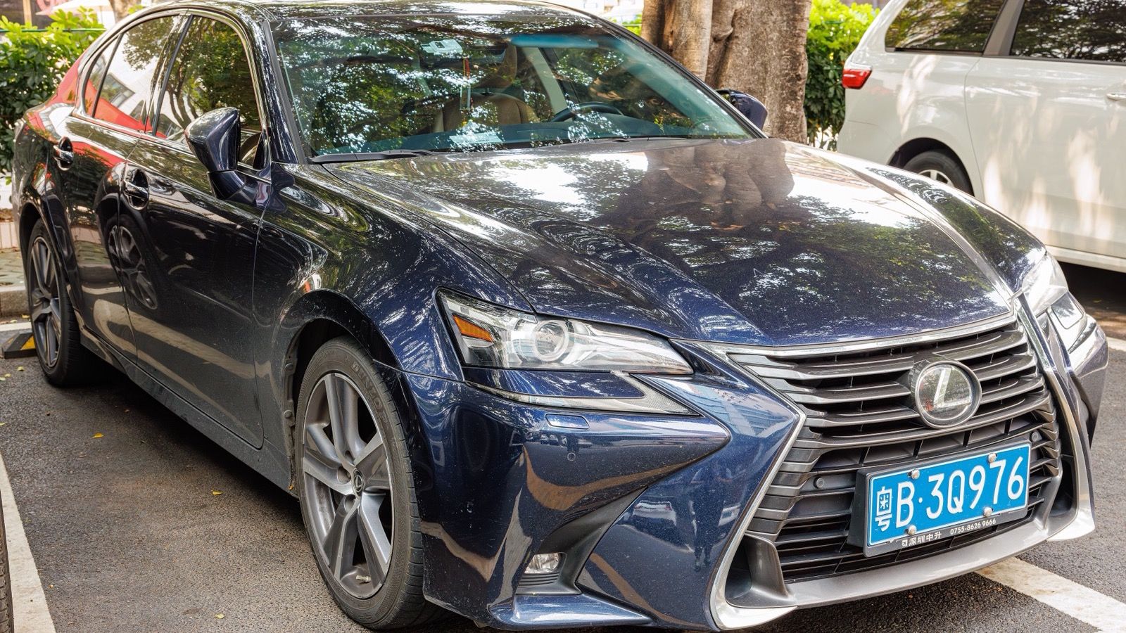 Dark blue fourth-generation Lexus GS sedan parked, front three-quarter view