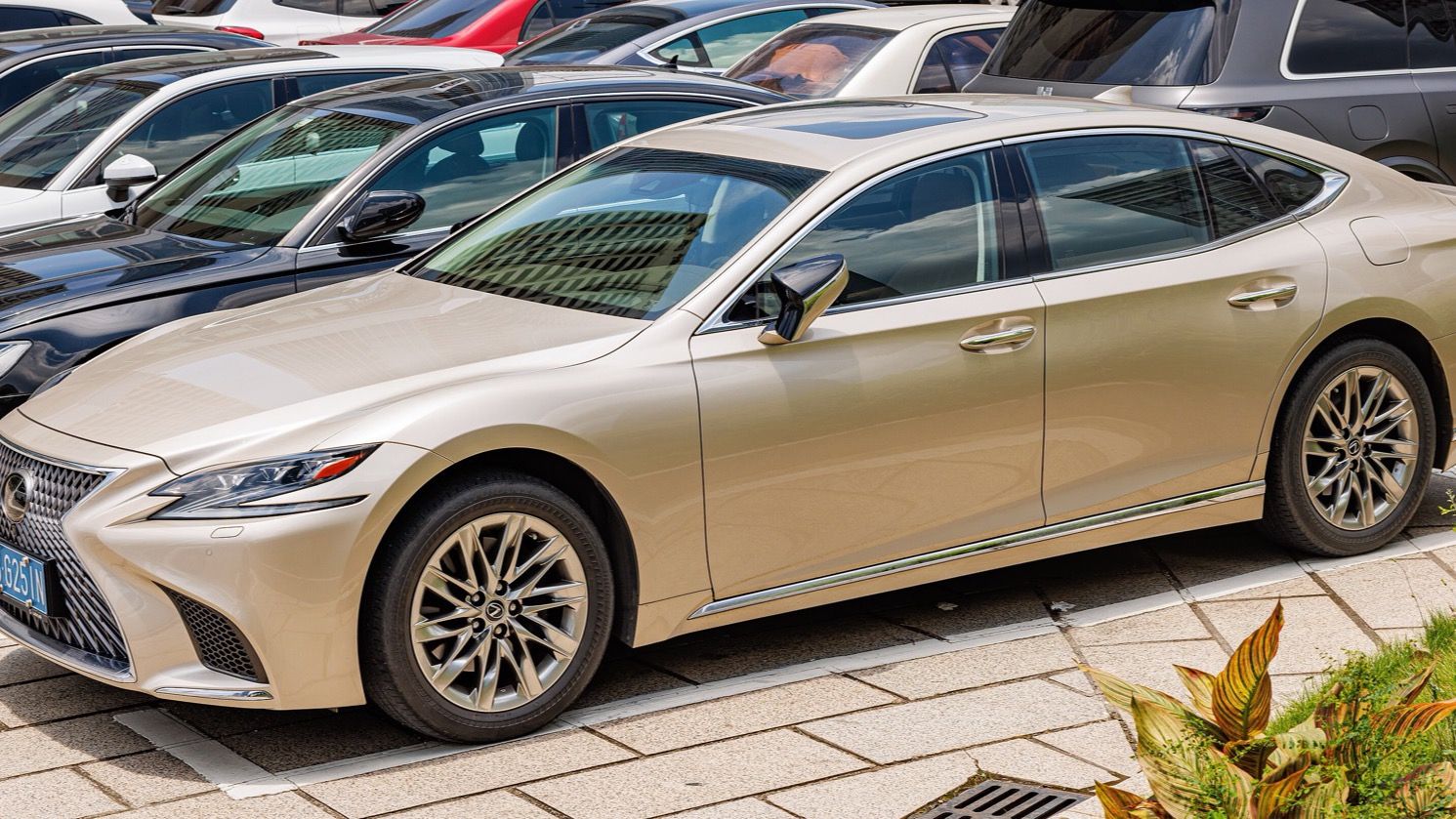 Champagne-gold fifth-generation Lexus LS sedan, front three-quarter view