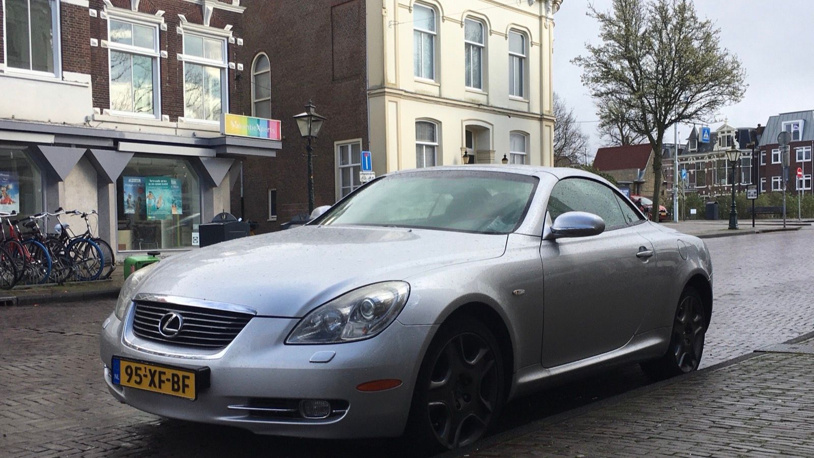 Silver 2007 Lexus SC 430 on a cobbled street, front three-quarter view
