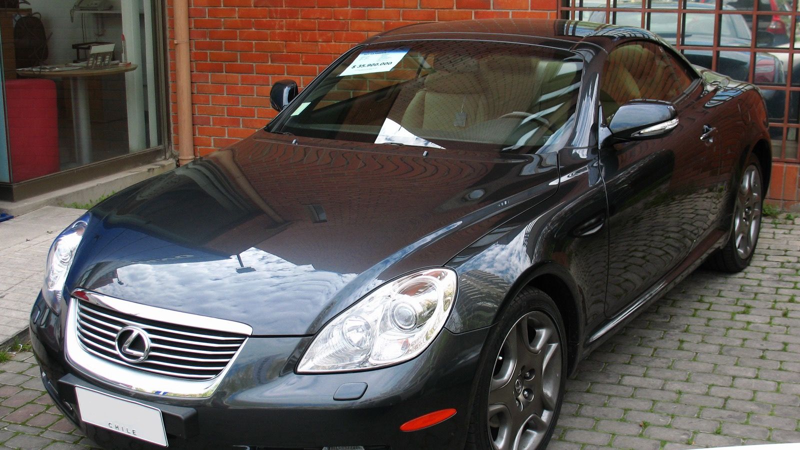 Dark grey 2009 Lexus SC 430 outside a showroom, front three-quarter view