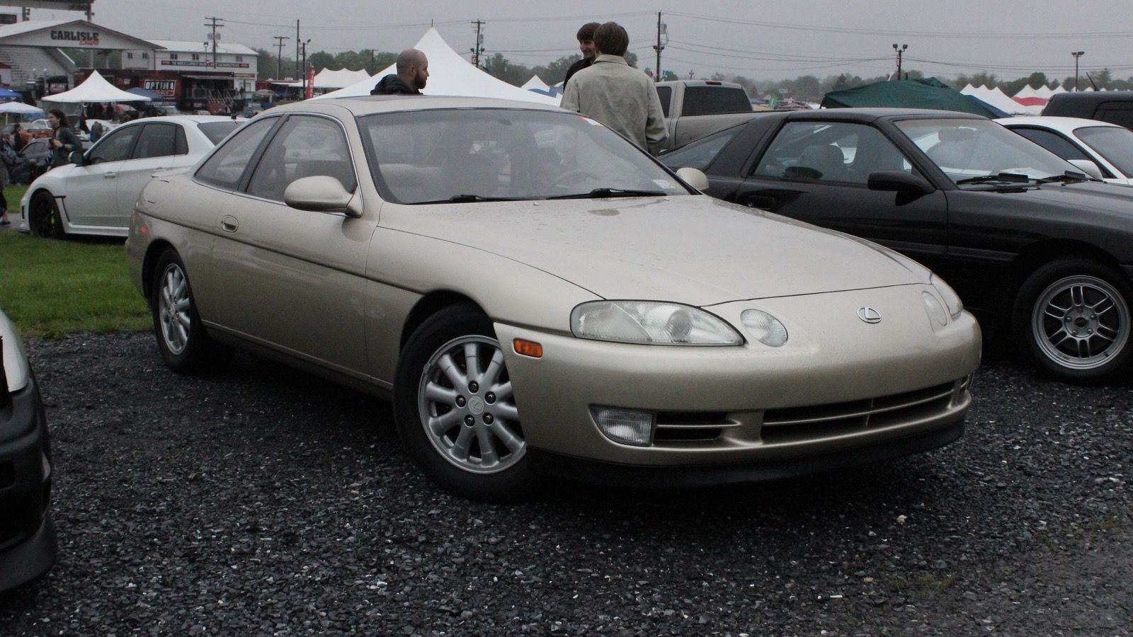 Champagne-gold Lexus SC 400 coupe at a car show, front three-quarter view