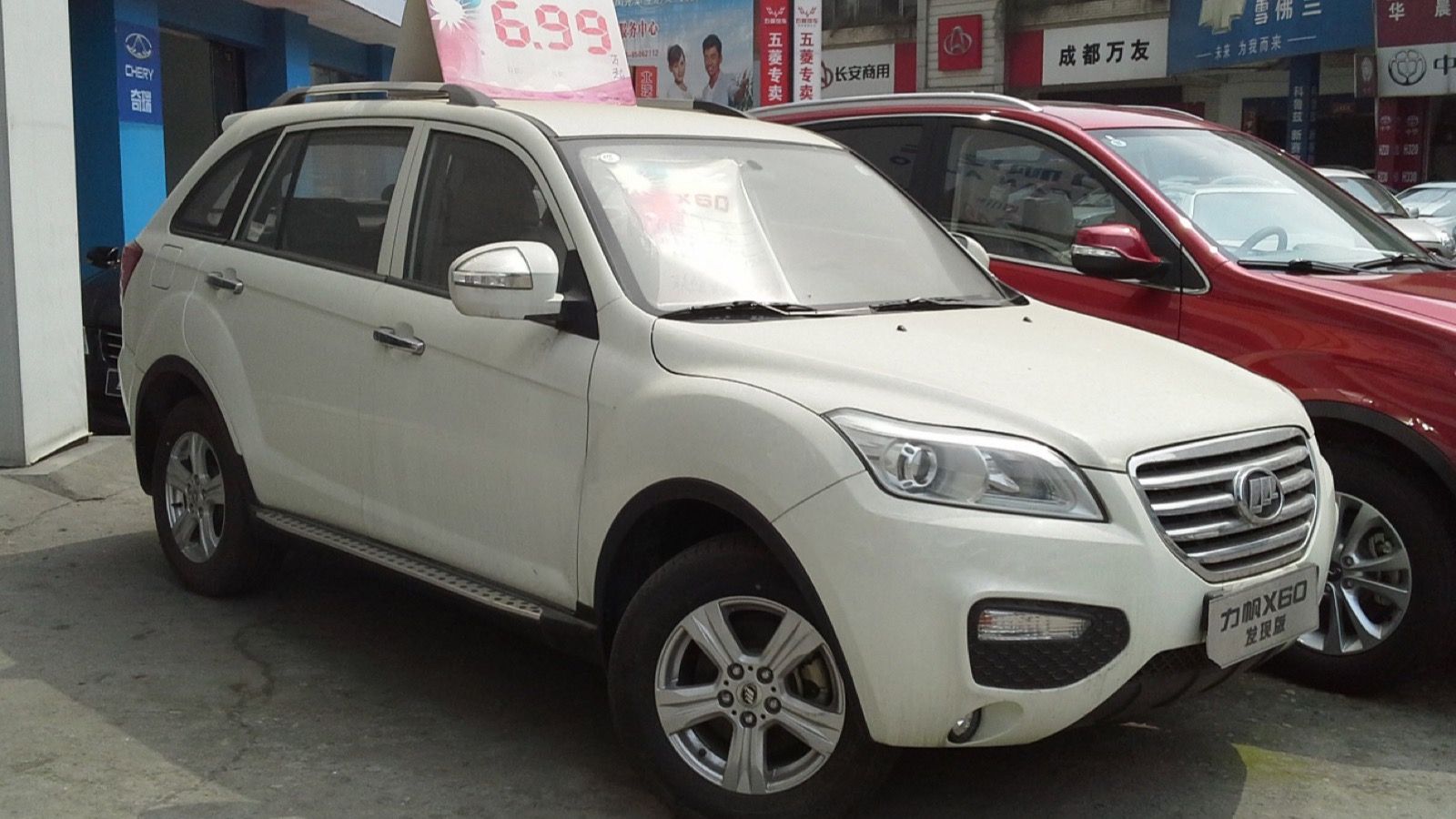 White Lifan X60 crossover at a Chinese dealership, front three-quarter view
