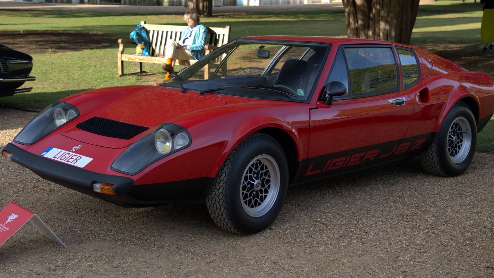 Red 1973 Ligier JS2 coupé on a concours lawn, front three-quarter view