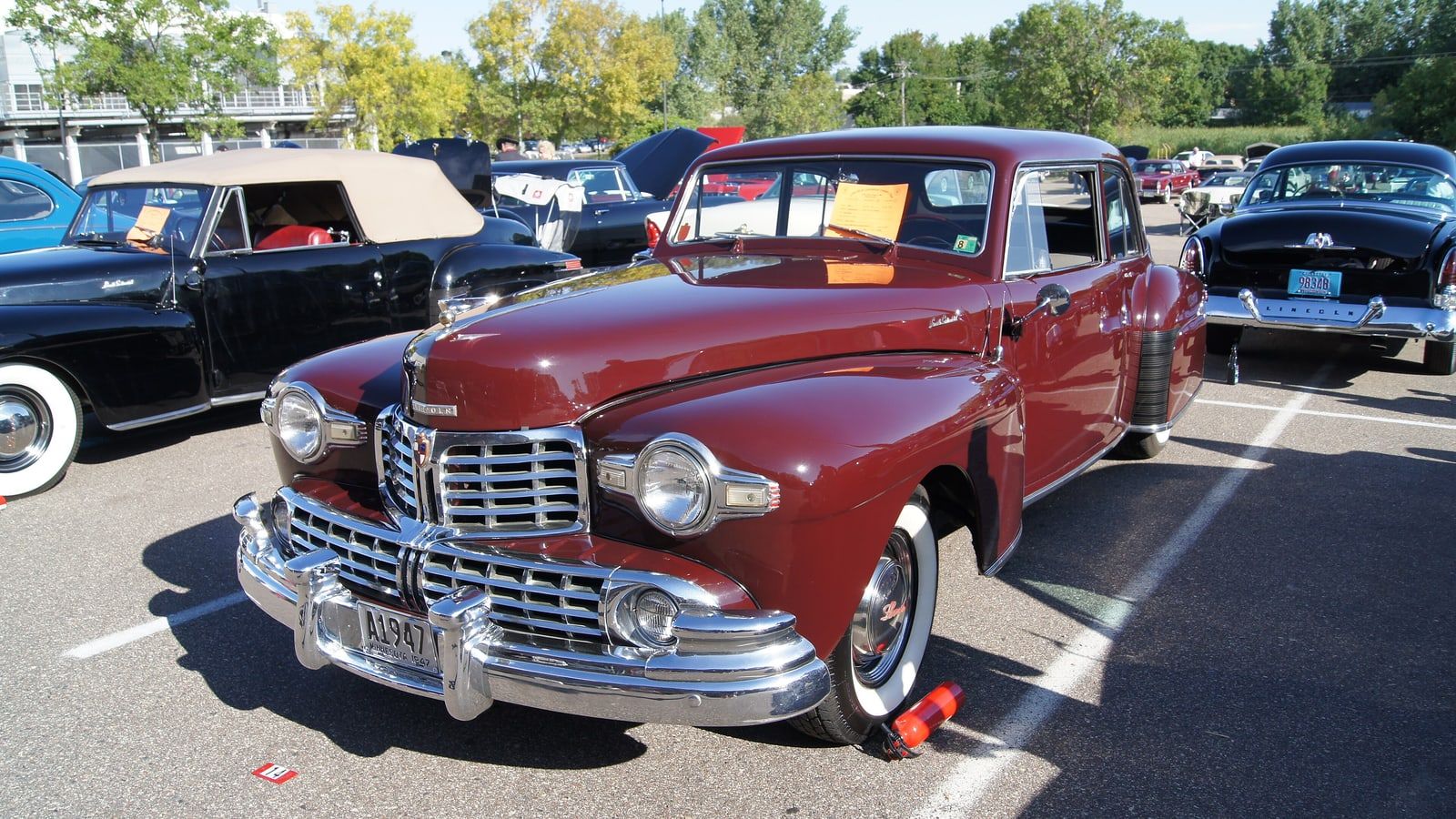 Maroon 1947 Lincoln Continental coupe, front three-quarter view at a car show