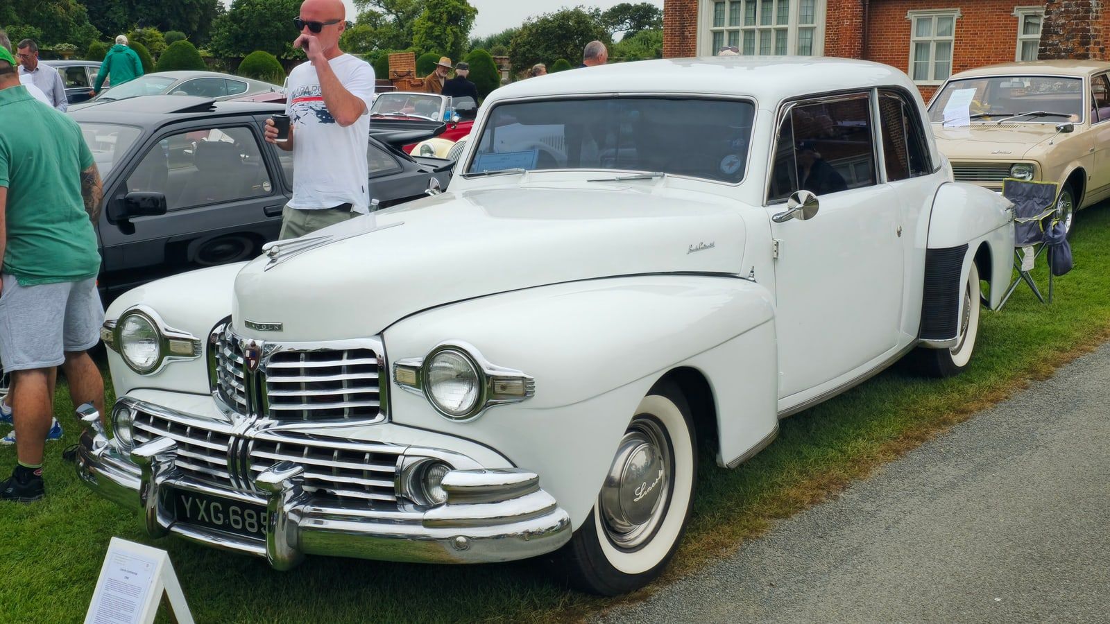 White 1948 Lincoln Continental coupe, front three-quarter view at an outdoor car show