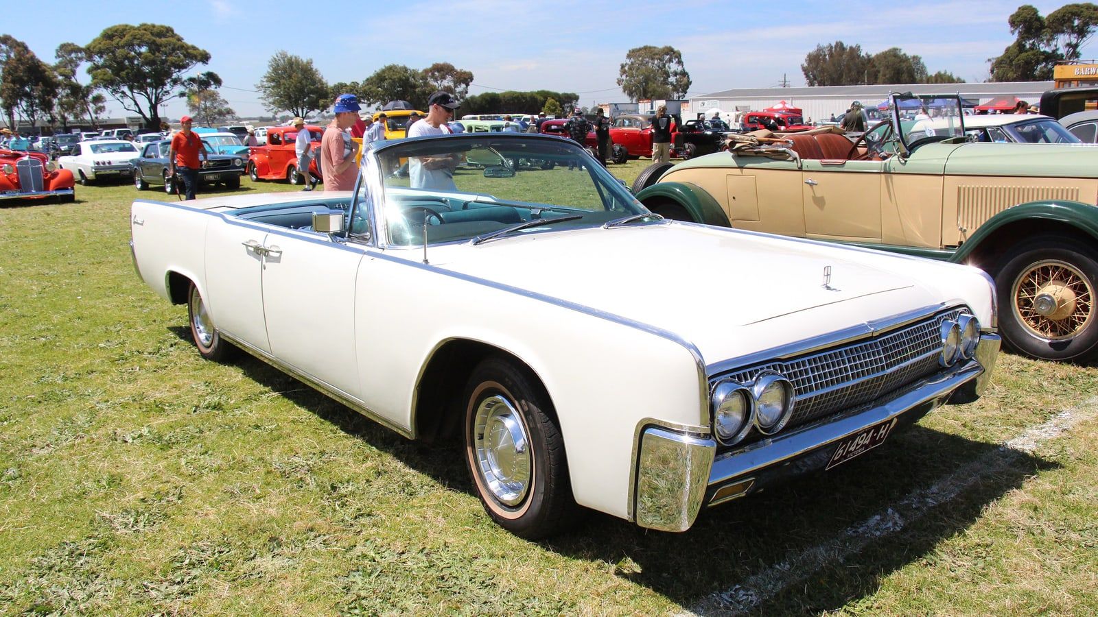 White 1963 Lincoln Continental convertible with the top down, front three-quarter view on grass